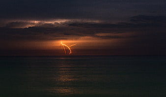 Dramatic Lightning Storm Over Ocean at Dusk