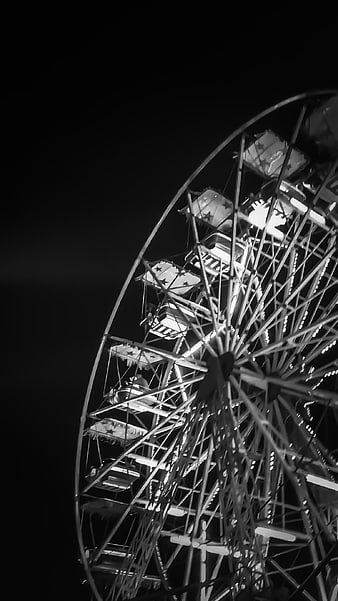 Black and white night photo of a lit Ferris wheel