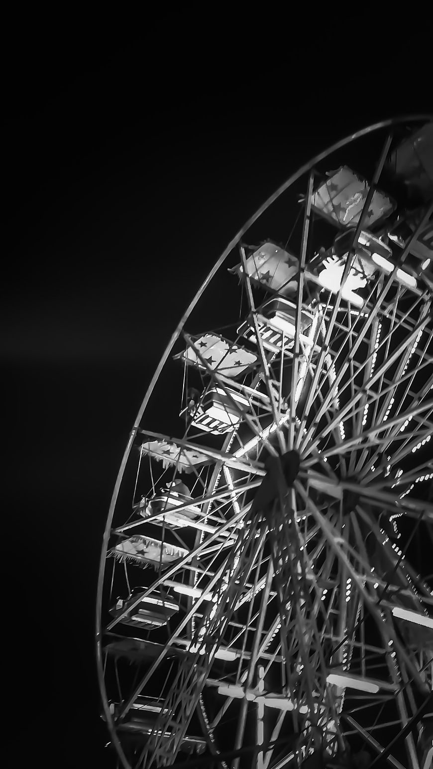 Black and white night photo of a lit Ferris wheel