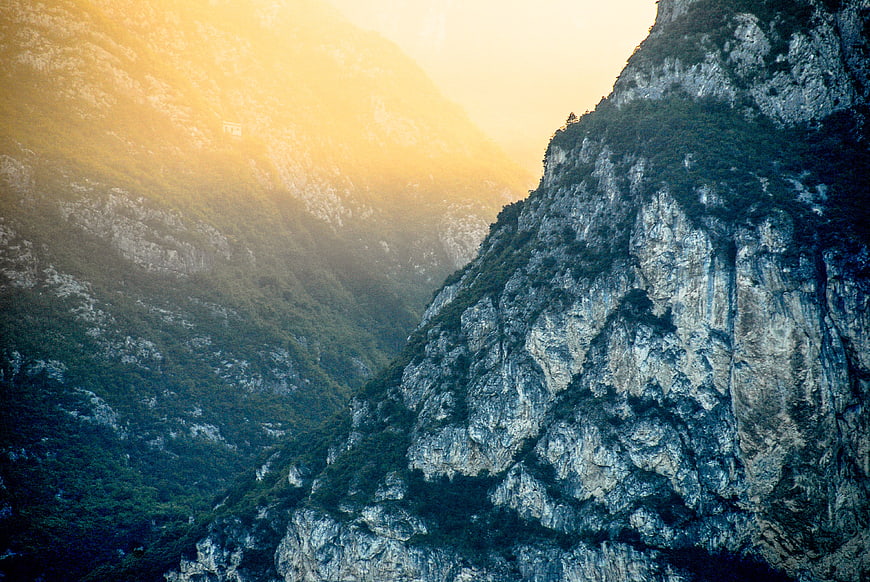 Dramatic Mountain Valley with Golden Sunlight and Rocky Cliffs
