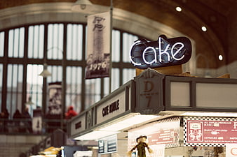 Neon Cake Sign at Indoor Market Stall