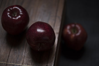 Three Red Apples on Wooden Surface