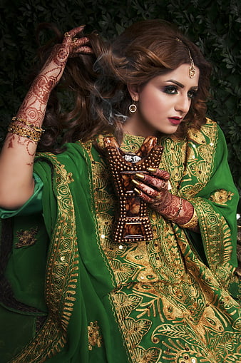 Indian Bride in Green Embroidered Dress with Henna and Incense