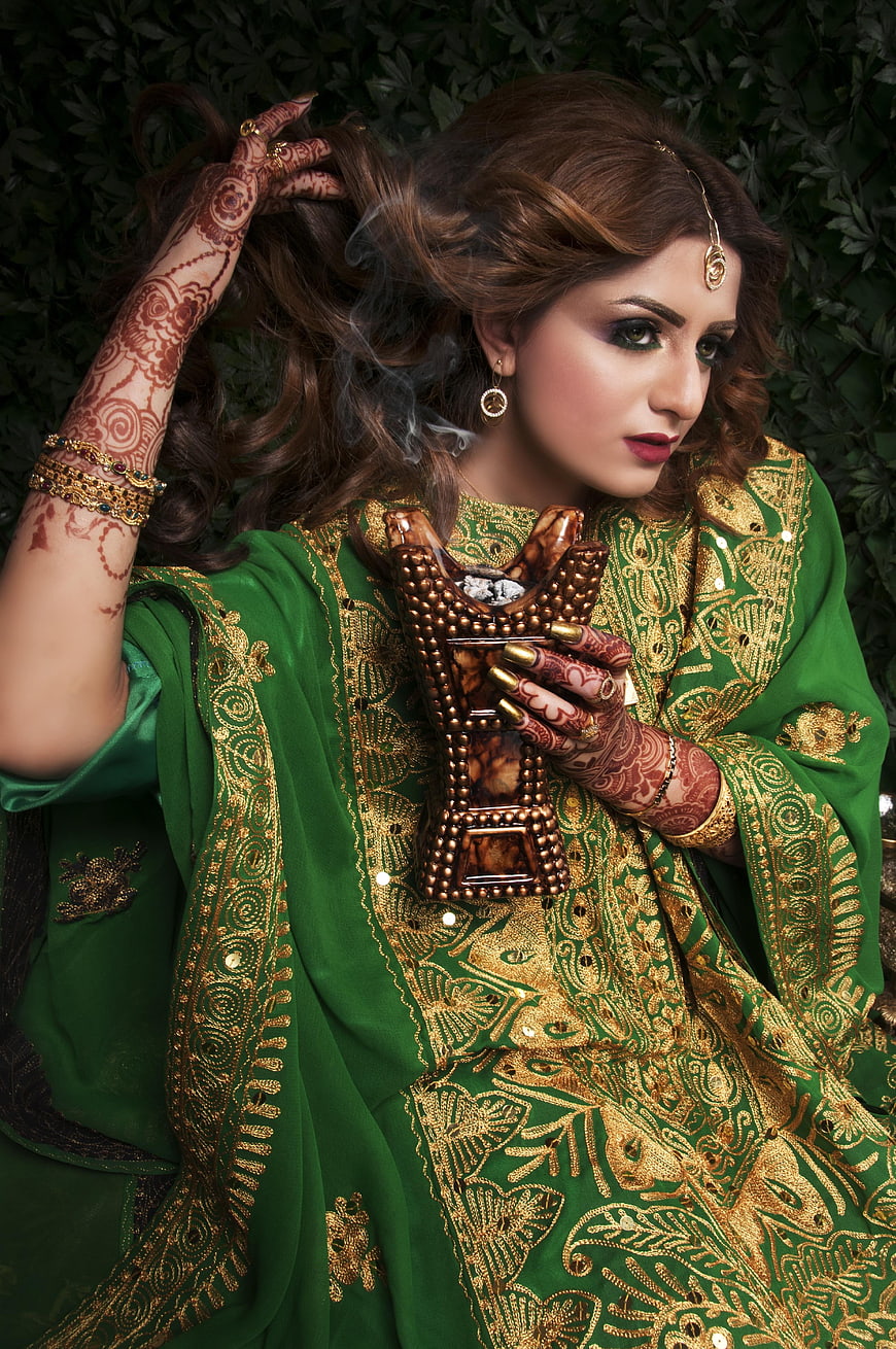 Indian Bride in Green Embroidered Dress with Henna and Incense