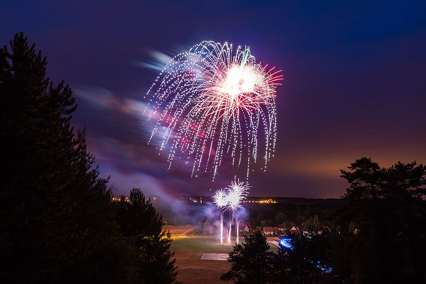 Fireworks Display Over Rural Landscape At Night