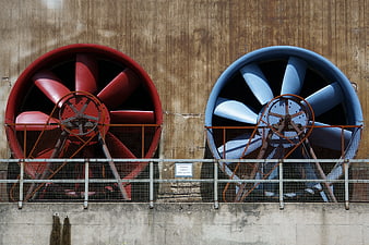 Red and Blue Industrial Exhaust Fans on Concrete Wall