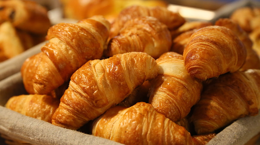 Fresh Golden Croissants in a Bakery Basket