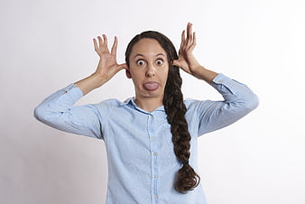 Playful woman making funny face with tongue out and claw hands