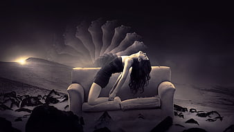Woman on couch with ghostly heads in surreal landscape