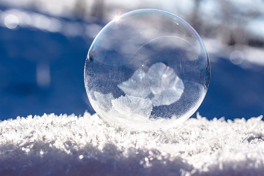Frozen Soap Bubble with Ice Crystals on Snow