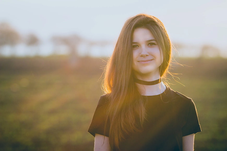 Young Woman with Long Hair in Golden Hour Backlight