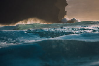 Cinematic Ocean Waves Crashing Against Rocky Cliff at Sunset