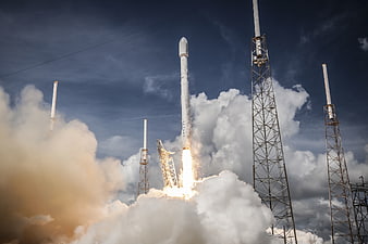 SpaceX Falcon 9 Rocket Launching into Blue Sky