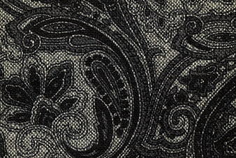Close-up of black and white paisley woven fabric texture