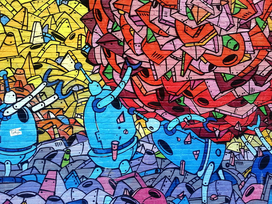 Colorful graffiti mural with blue robots and abstract shapes