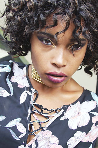 Portrait of Woman with Gold Eye Makeup and Floral Dress