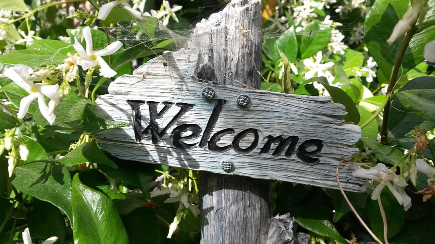 Rustic Welcome Sign in Garden with White Flowers