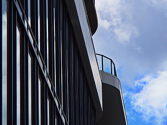 Modern Office Building Facade with Blue Sky Background