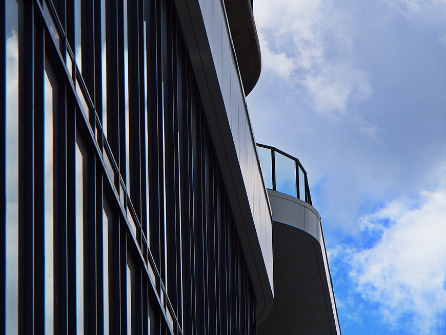 Modern Office Building Facade with Blue Sky Background