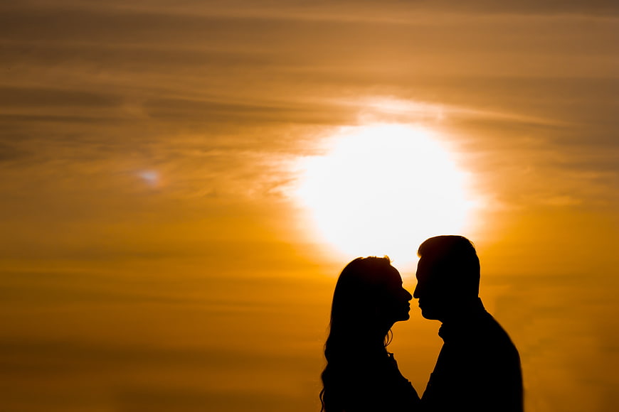 Silhouette of Romantic Couple About to Kiss at Sunset