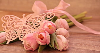 Pink Tulips with Butterfly Ornament and Ribbon on Wooden Surface
