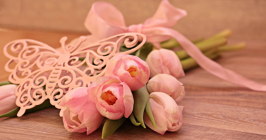 Pink Tulips with Butterfly Ornament and Ribbon on Wooden Surface