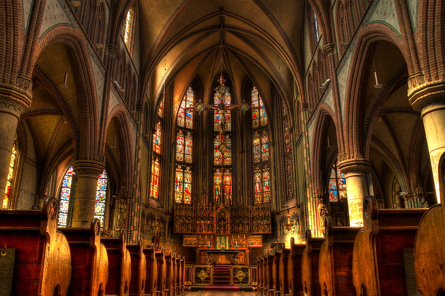 Gothic Church Interior with Stained Glass Windows and Altar