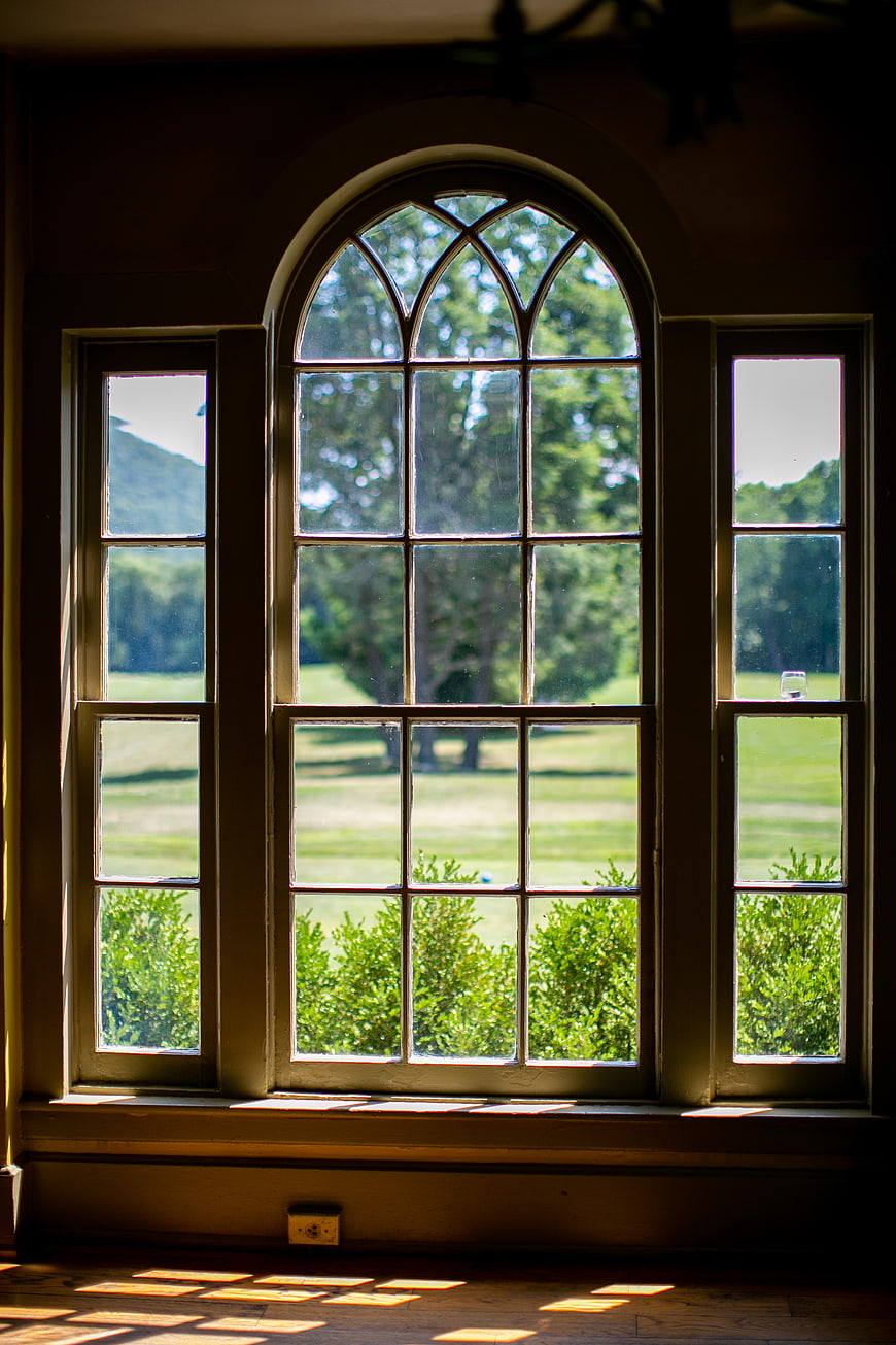 Sunlit Arched Window with Garden View