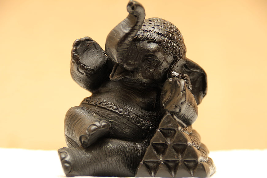 Black Ganesha Statue Sculpture on Beige Background