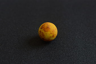 Yellow textured sphere on black background