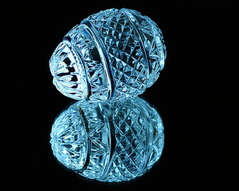 Blue Crystal Egg with Reflection on Black Background