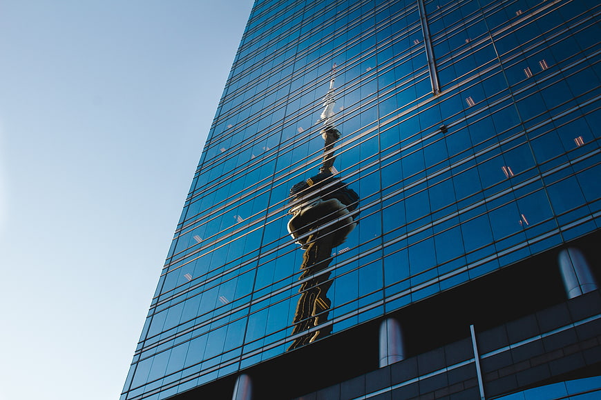 Reflection of CN Tower on Blue Glass Skyscraper