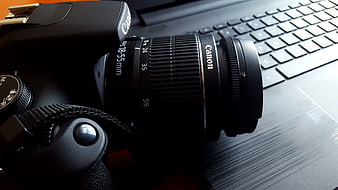 Close-up of Canon DSLR Camera on Laptop Keyboard