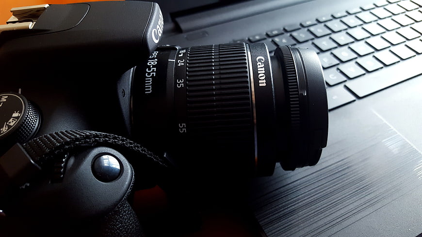 Close-up of Canon DSLR Camera on Laptop Keyboard