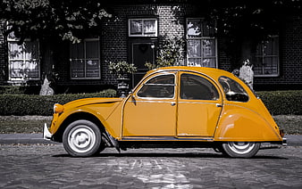 Vintage Yellow Citroen 2CV Parked on Cobblestone Street