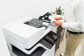 Businessman using office copier machine