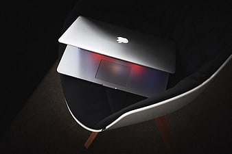 Silver Laptop on Modern Chair with Dramatic Lighting