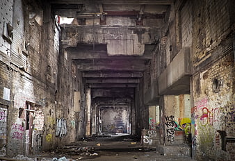 Abandoned industrial factory interior with graffiti and decay