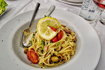 Linguine Pasta with Lemon, Tomatoes, and Olives on White Plate
