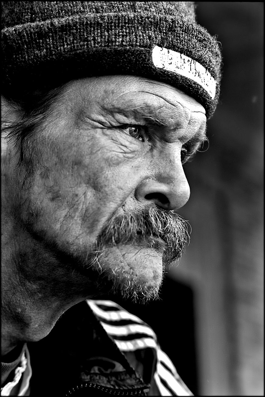 Black and white profile portrait of an elderly man with a weathered face