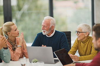 Senior couple meeting with financial advisor in office