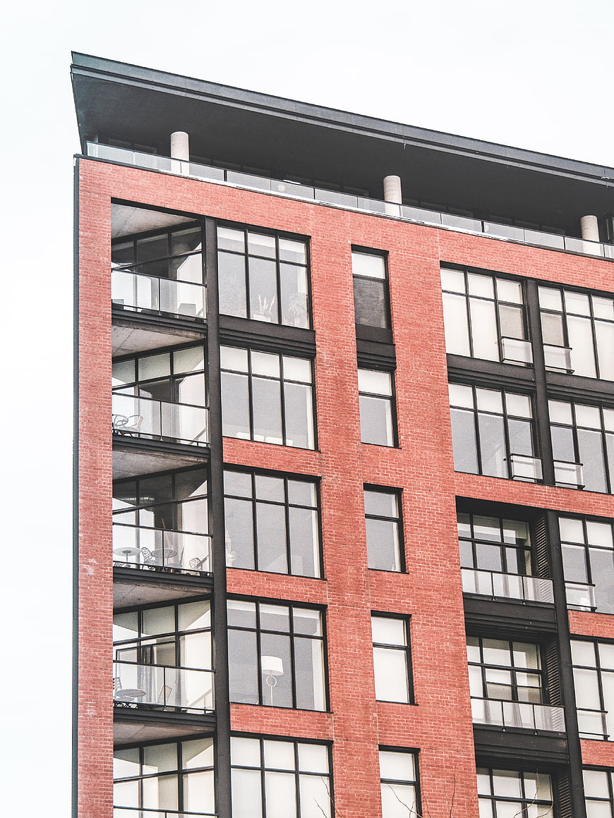 Modern Red Brick Building Facade with Black Windows
