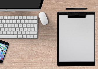 Top-Down Office Desk Setup With Clipboard, Keyboard, Mouse, And Smartphone