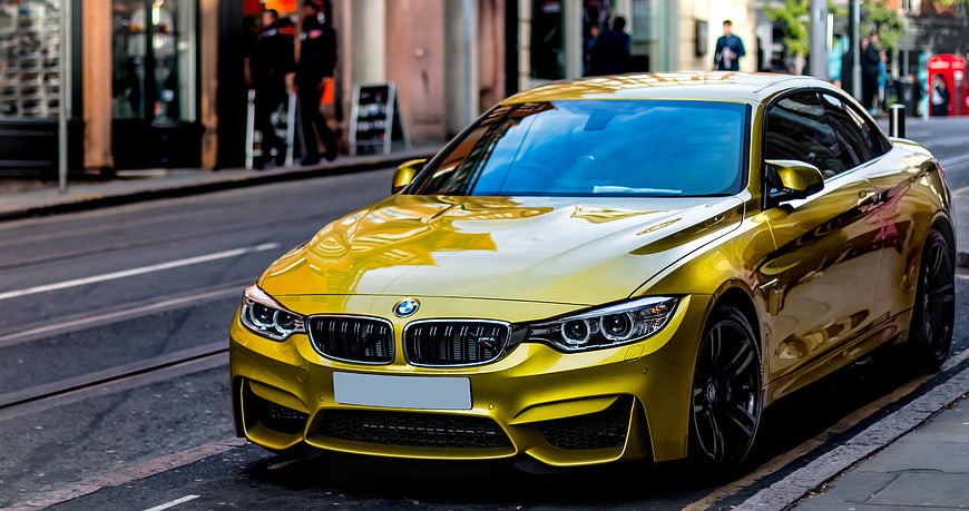 Yellow BMW M4 Coupe Parked on City Street
