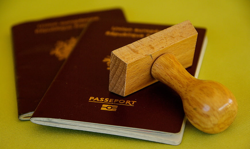 French Passports with Wooden Stamp on Yellow Background