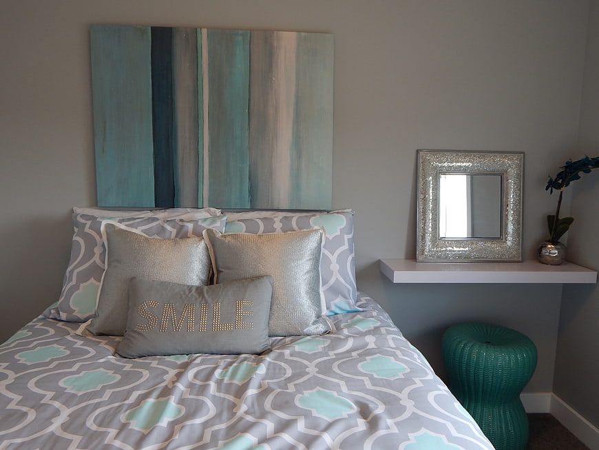 Modern Bedroom Interior With Gray And Teal Bedding And Abstract Wall Art