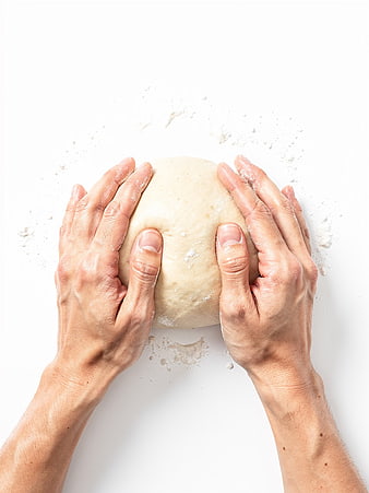 Hands Kneading Bread Dough on White Surface
