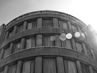 Low angle black and white curved office building facade