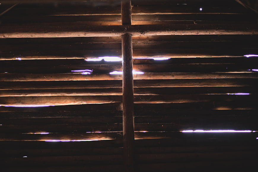 Light Leaks Through Wooden Slats in Dark Interior