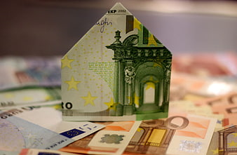 Euro banknote folded into house shape on money background